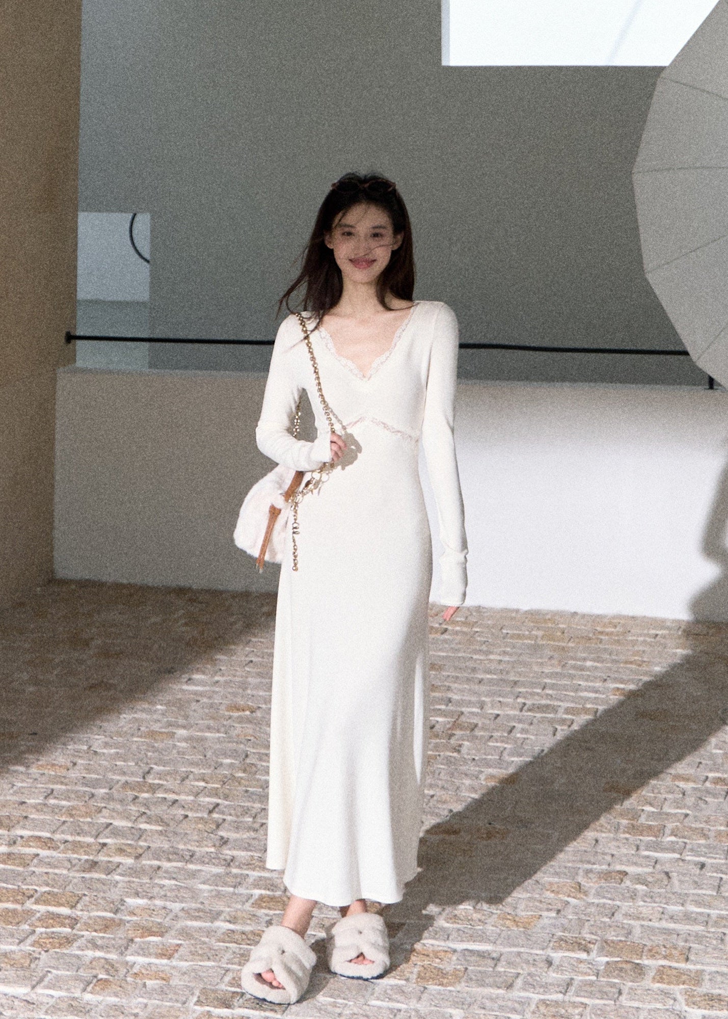 Elegant ivory long sleeve maxi dress with flowing flared skirt