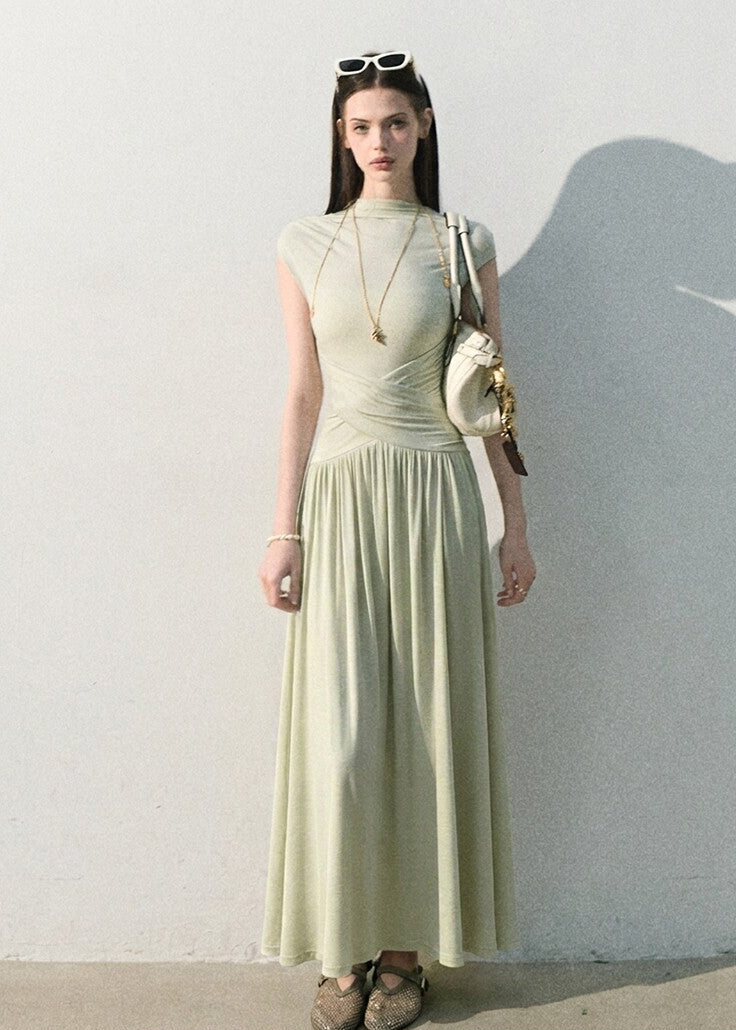 Model wearing a soft knit maxi dress with fluid drape