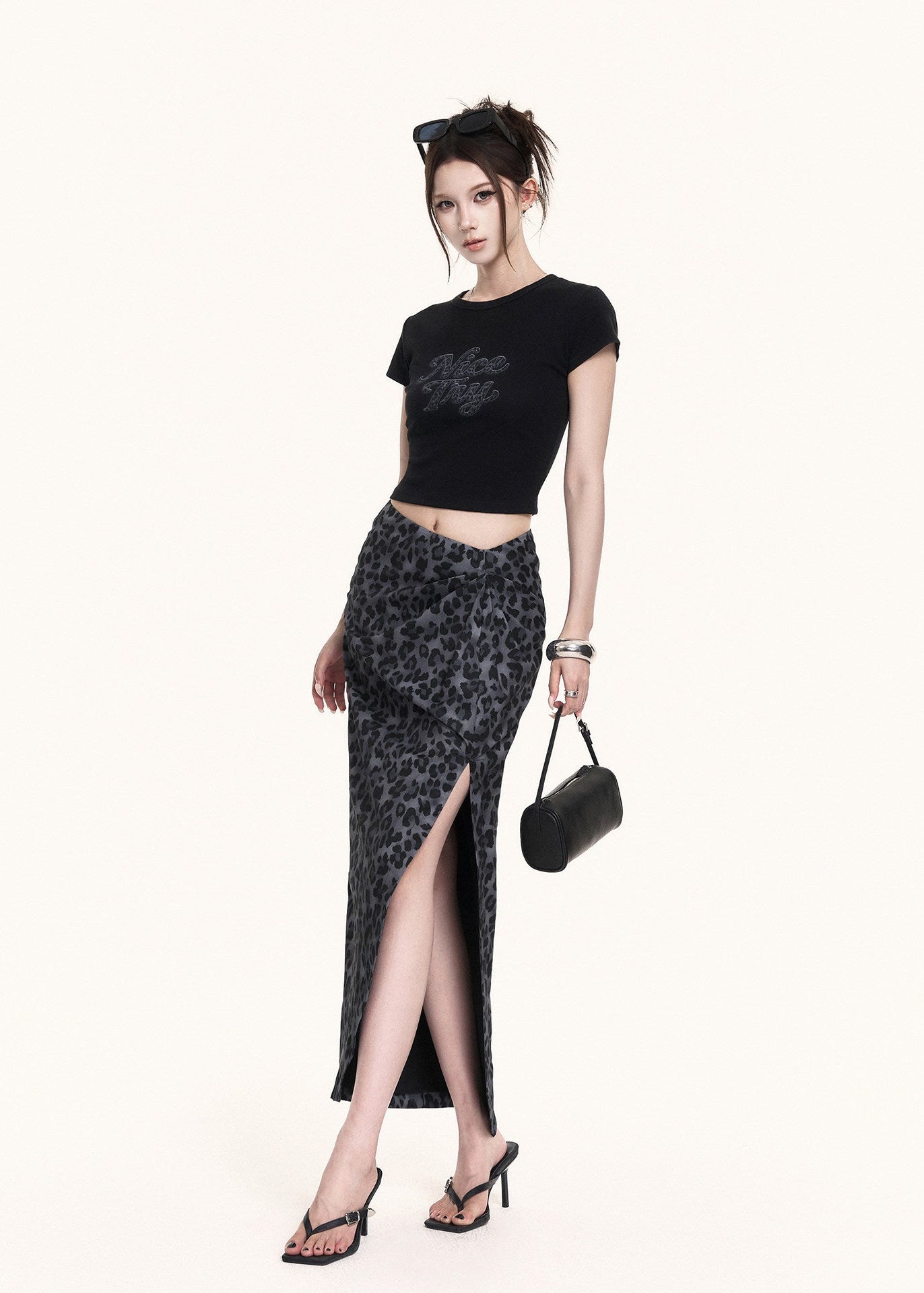 Black crewneck crop tee paired with a leopard maxi skirt