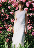 White one-shoulder maxi dress with cascading ruffle detail
