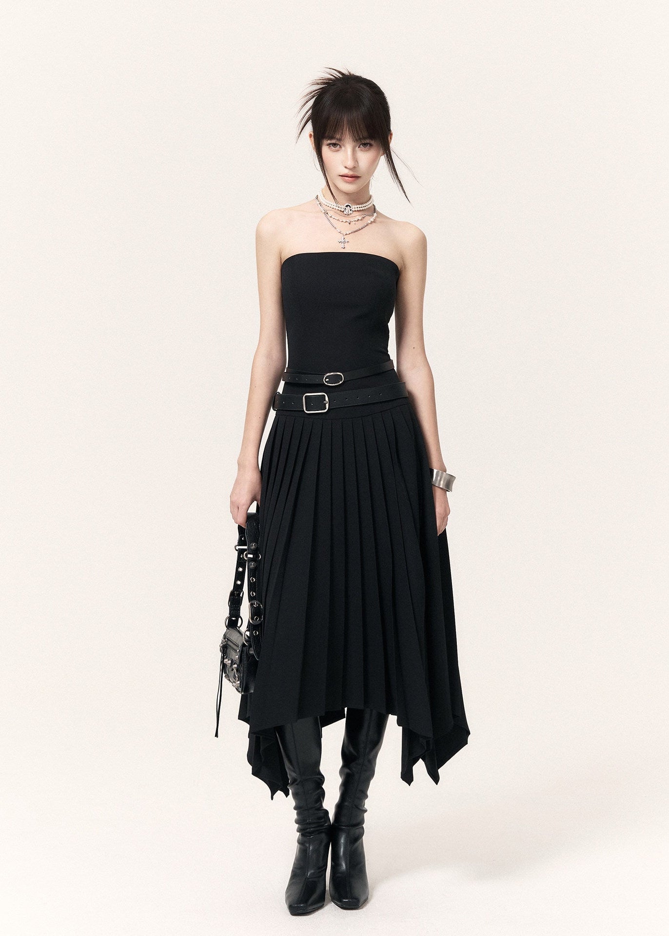Strapless black pleated dress featuring a removable buckle belt