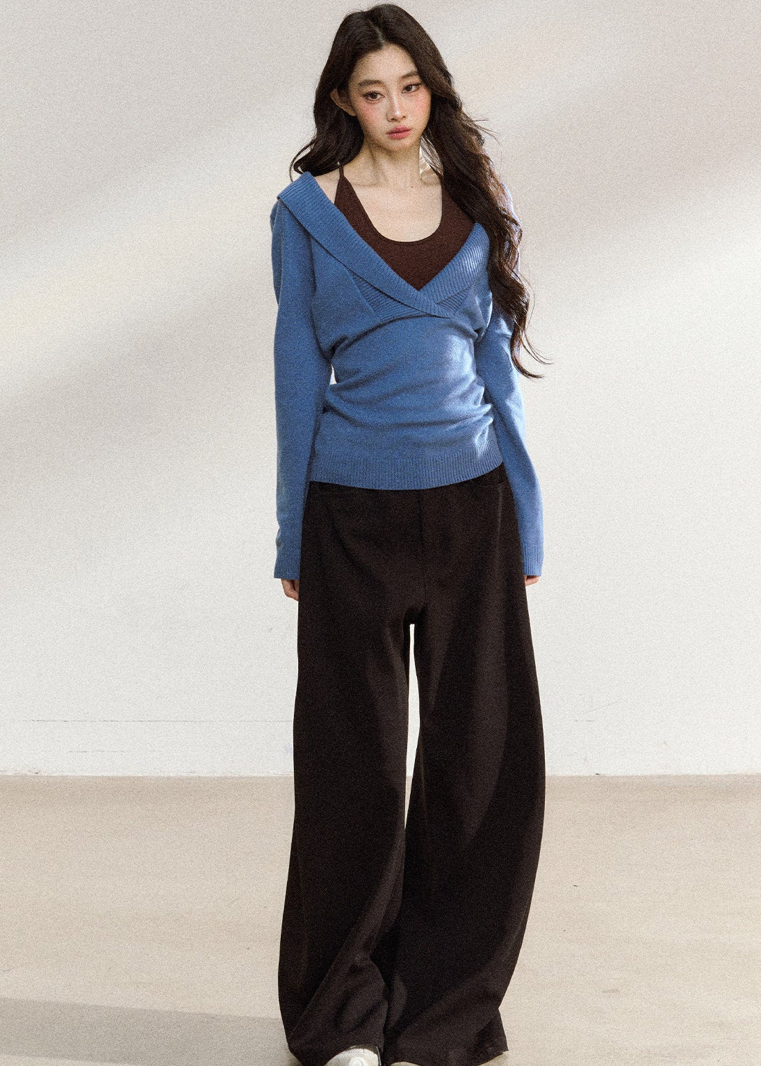 Women’s blue wrap-front sweater with relaxed shoulders