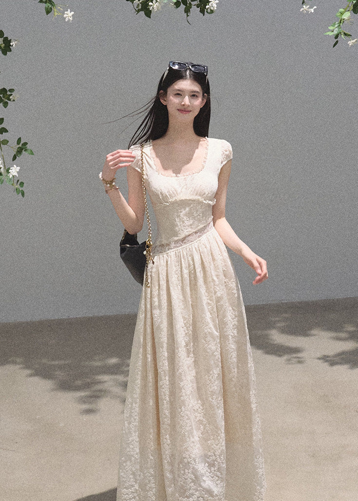 Elegant cream gown with flowing skirt and cap sleeves