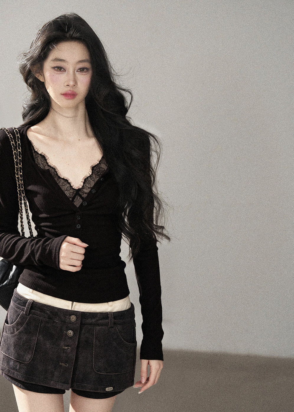Feminine black lace-detail fitted top styled with denim mini skirt