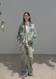 Oversized faded denim jacket with distressed details and gold-tone buttons