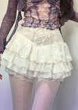 White layered lace mini skirt with ruffle hem