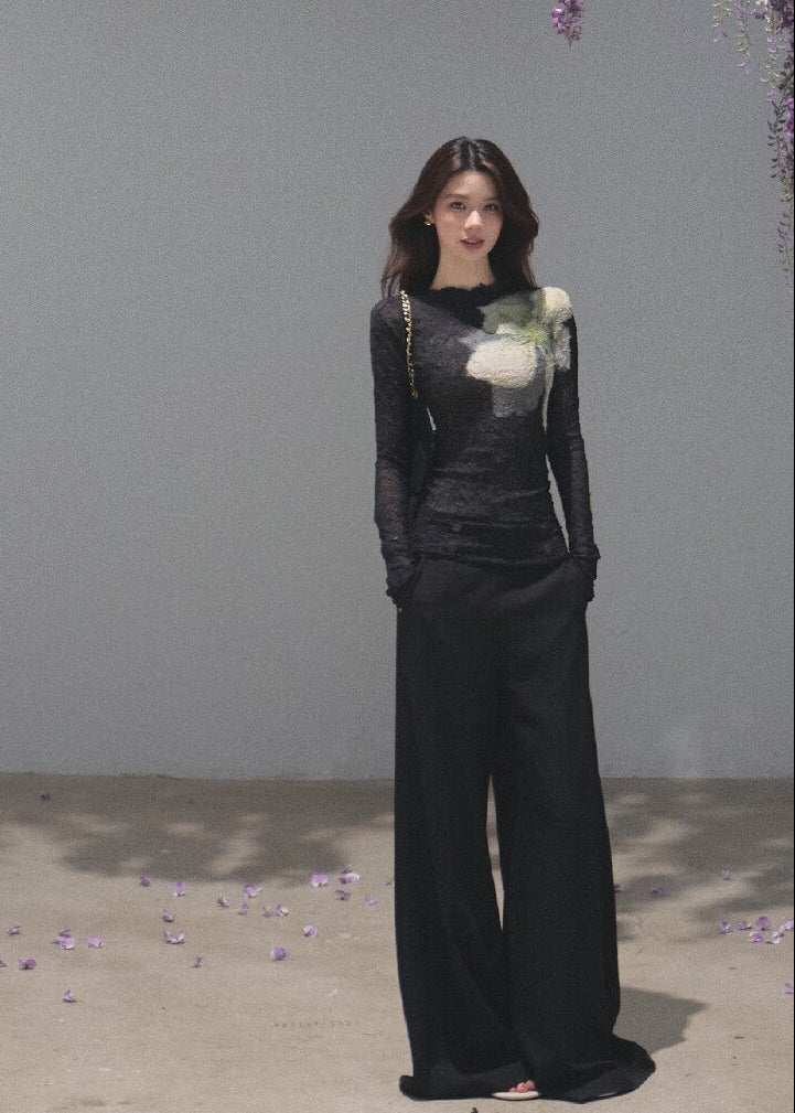 Model wearing a black botanical-print long-sleeve base layer