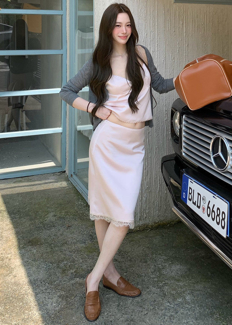 Models wearing pink and black lace-trim camisole and midi skirt sets