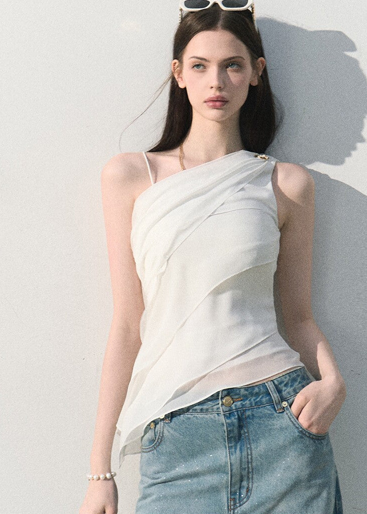 White asymmetric draped top styled with light-wash jeans
