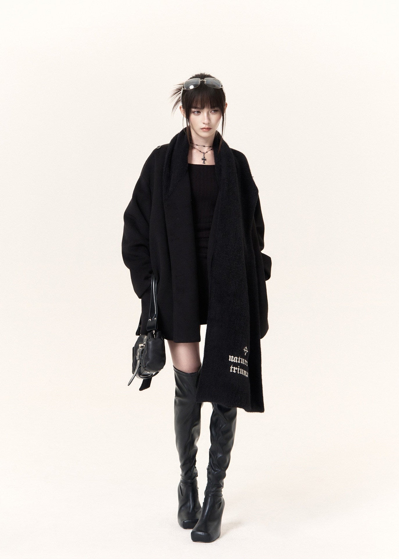 Women's black short coat with oversized draped scarf and buckle belt