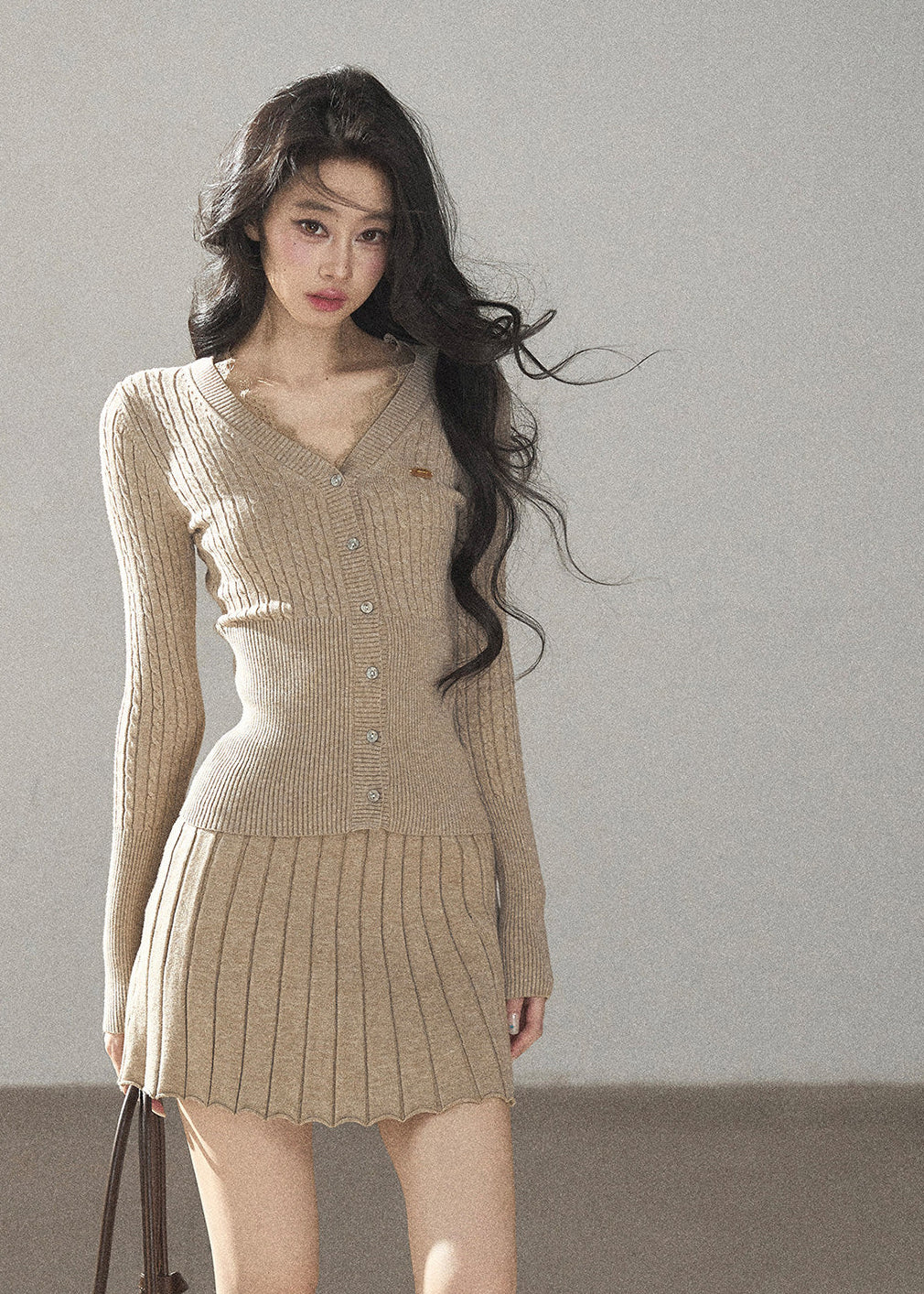 Women's fitted V-neck button cardigan with matching pleated knit skirt