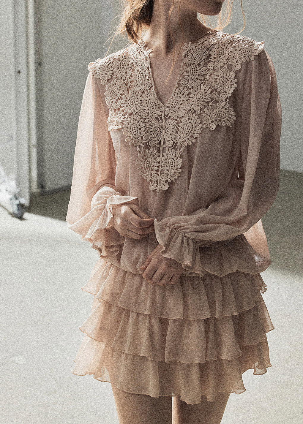 Soft blush vacation outfit with a tiered ruffle mini skirt
