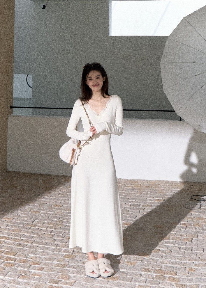 Elegant ivory long sleeve maxi dress with flowing flared skirt