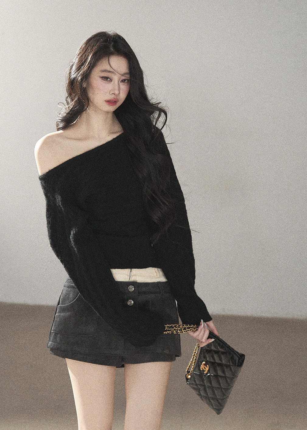 Black asymmetric off-shoulder cable knit sweater with long sleeves