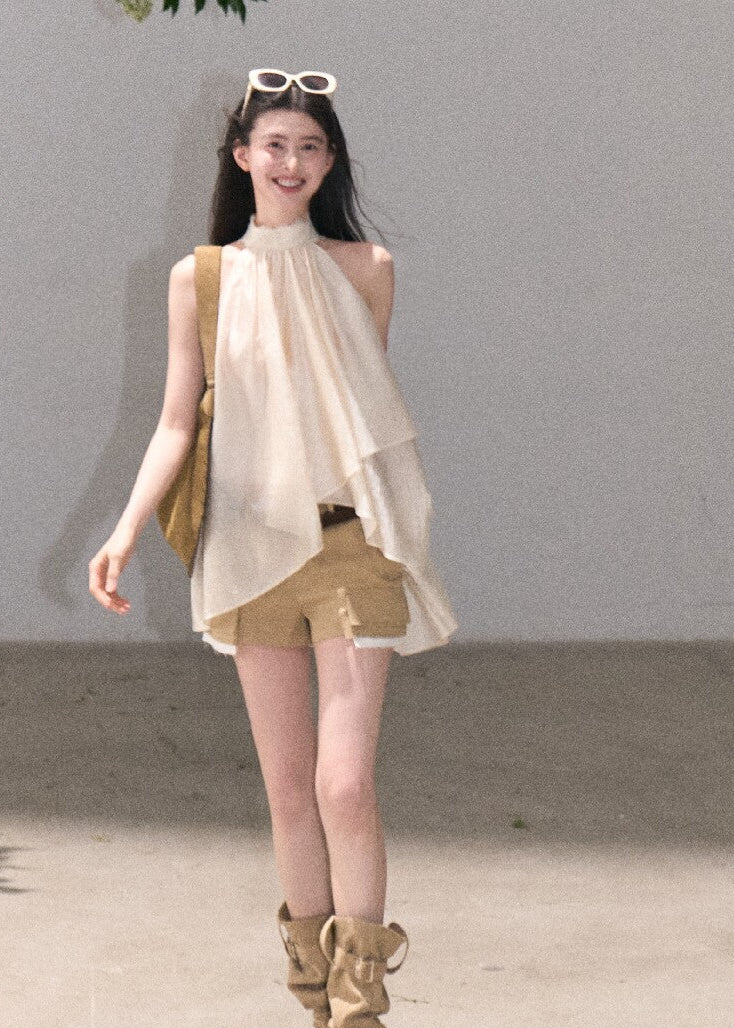 Resort-style cream top with flowing layered shape