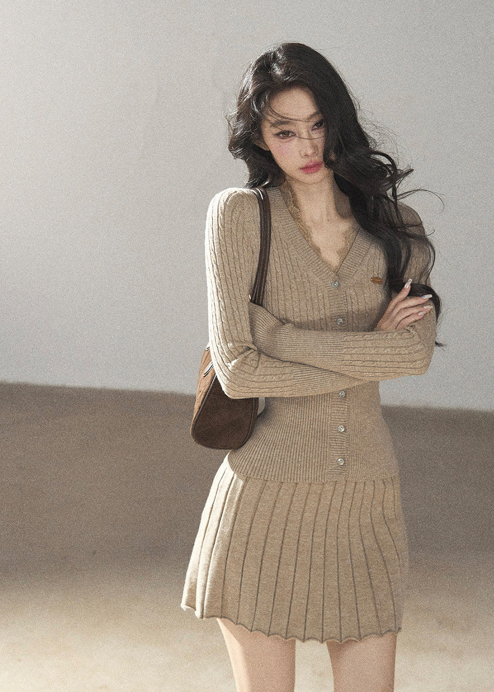 Women's fitted V-neck button cardigan with matching pleated knit skirt