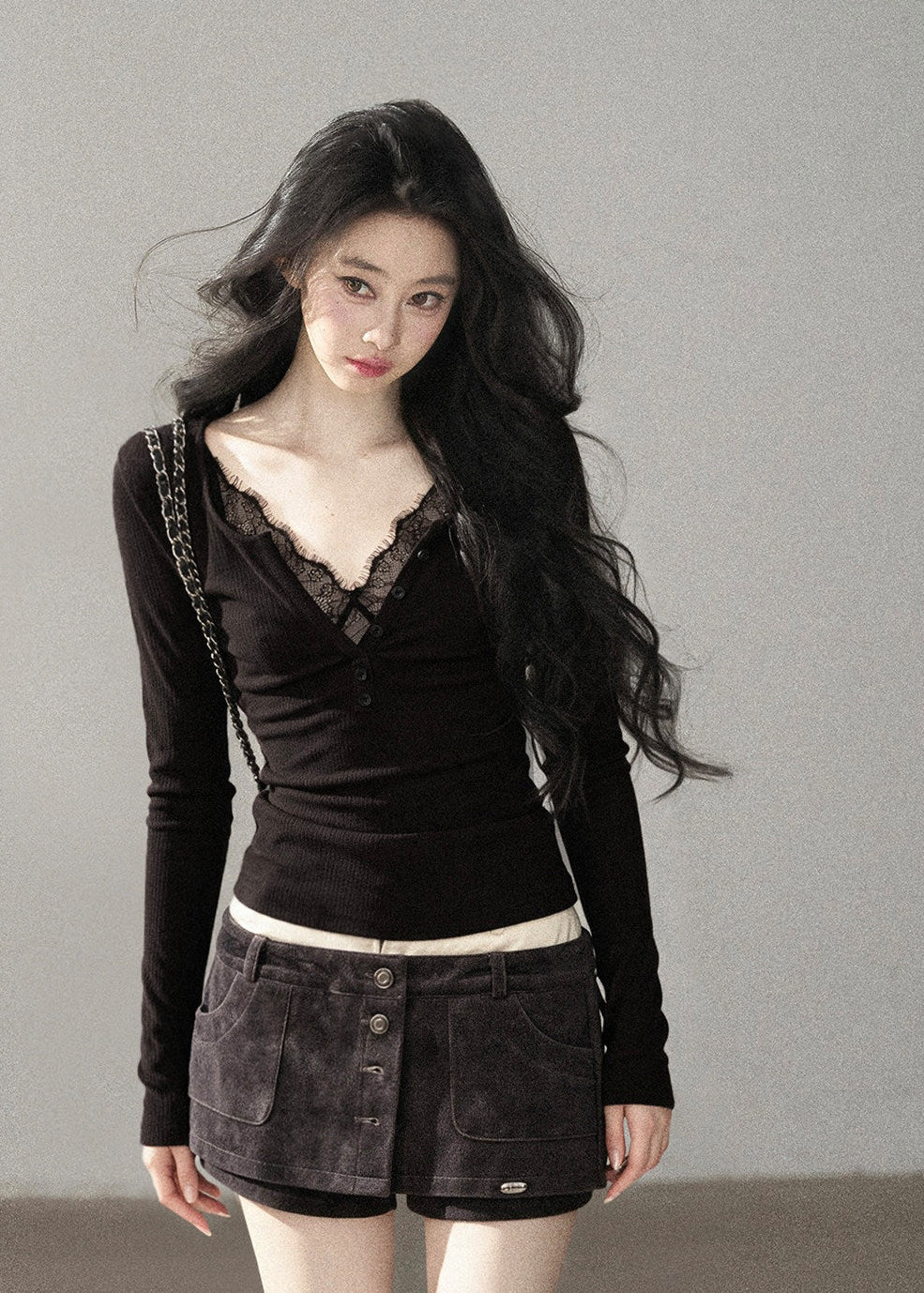 Feminine black lace-detail fitted top styled with denim mini skirt