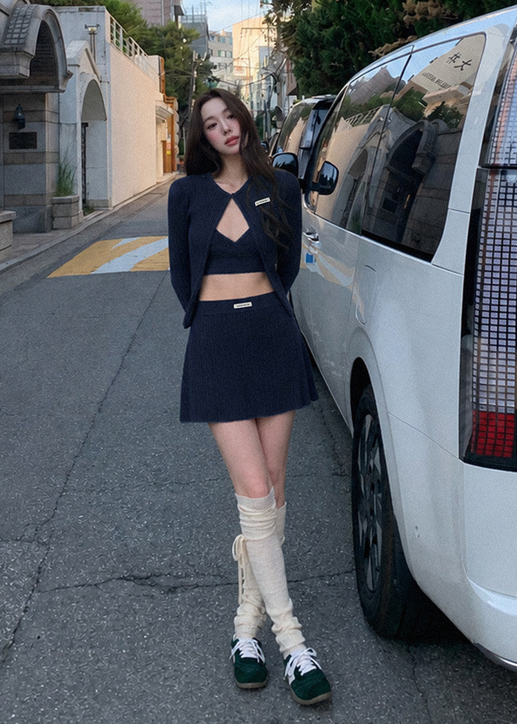 Black knit cardigan set with a matching camisole and flared mini skirt