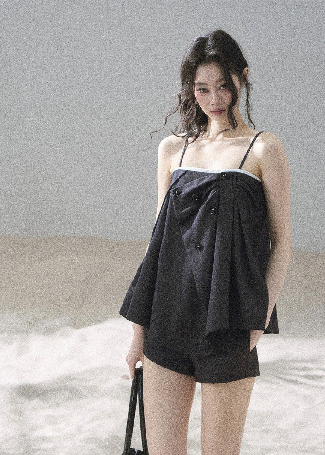 Flowing black camisole with suit-inspired front detailing