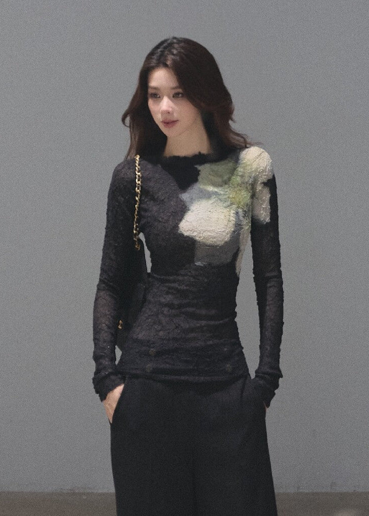Model wearing a black botanical-print long-sleeve base layer