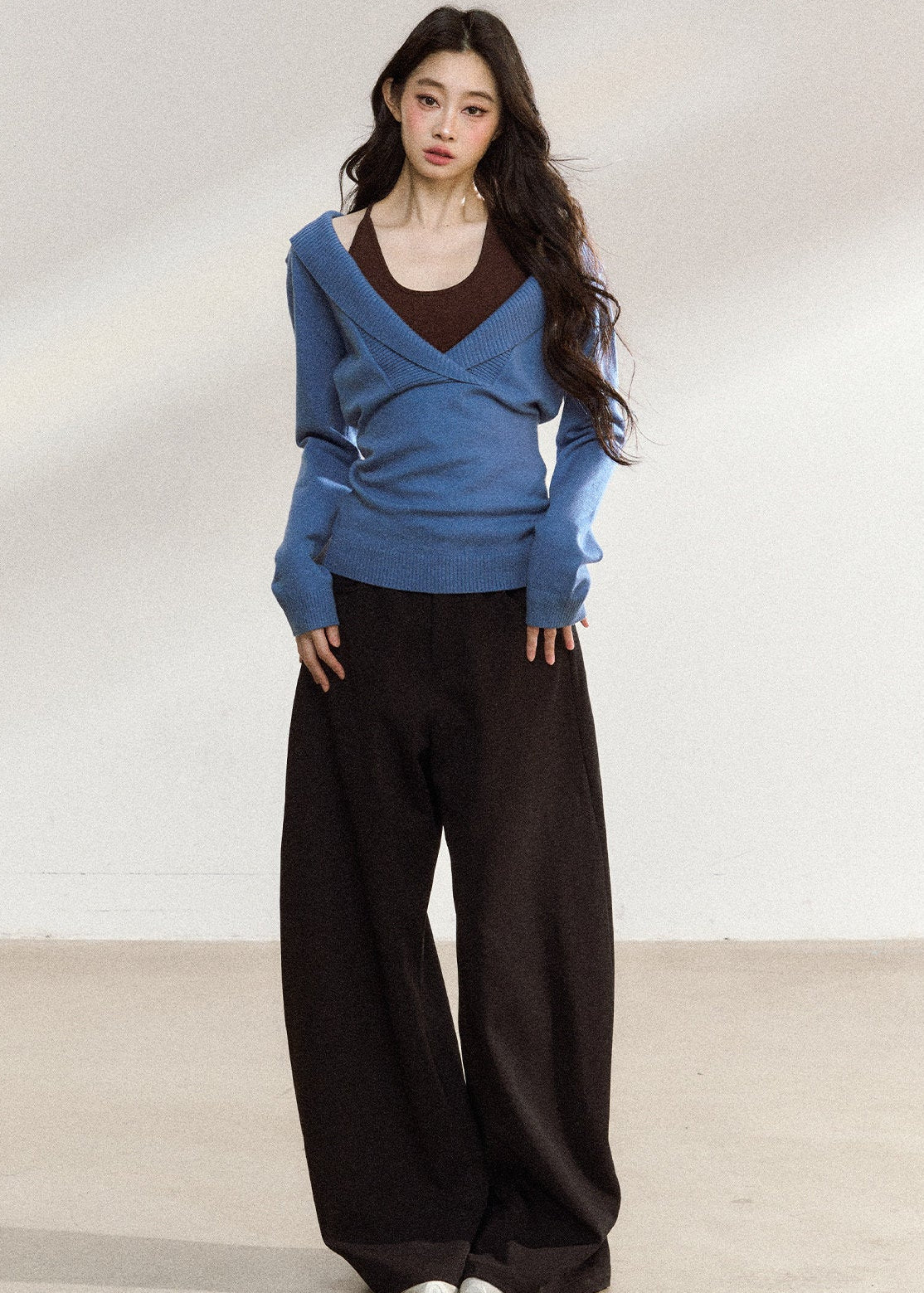 Women’s blue wrap-front sweater with relaxed shoulders