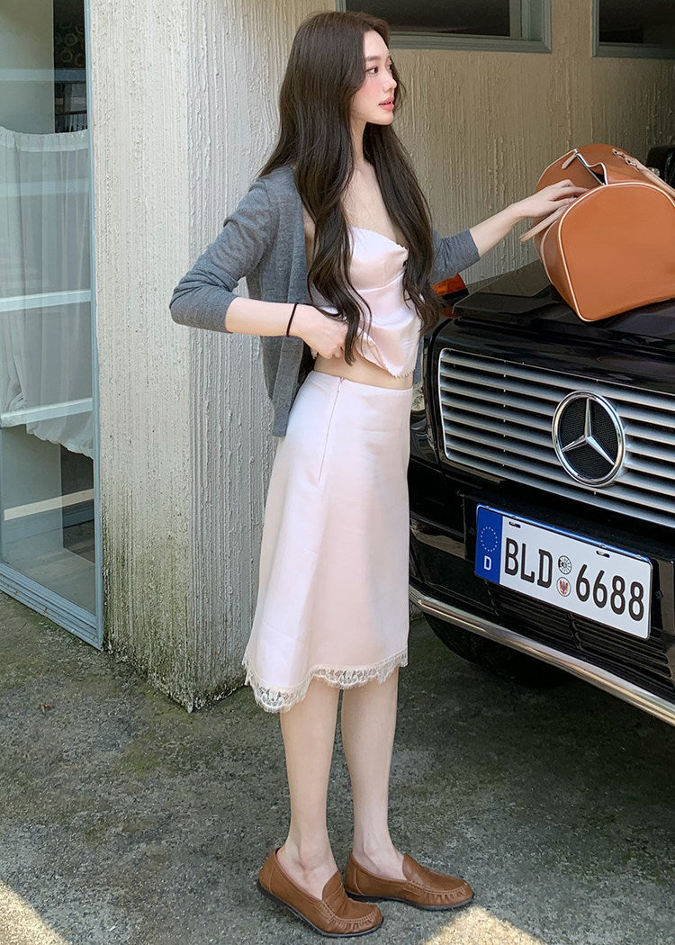 Models wearing pink and black lace-trim camisole and midi skirt sets