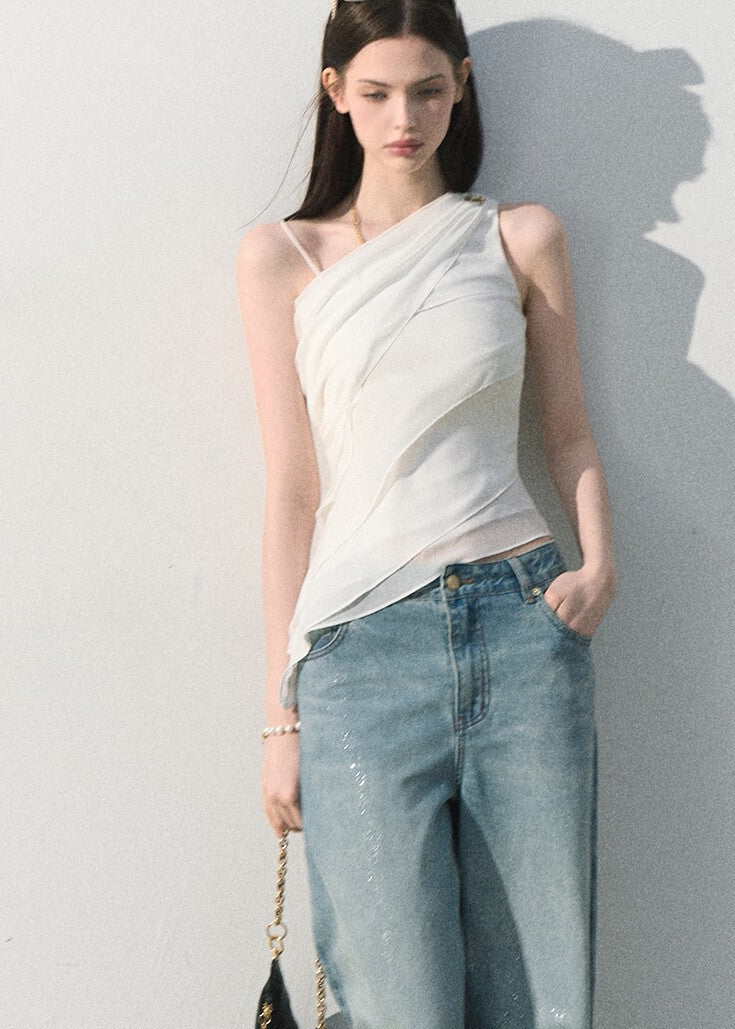 One-shoulder white top with soft layered drape detail