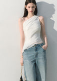 One-shoulder white top with soft layered drape detail