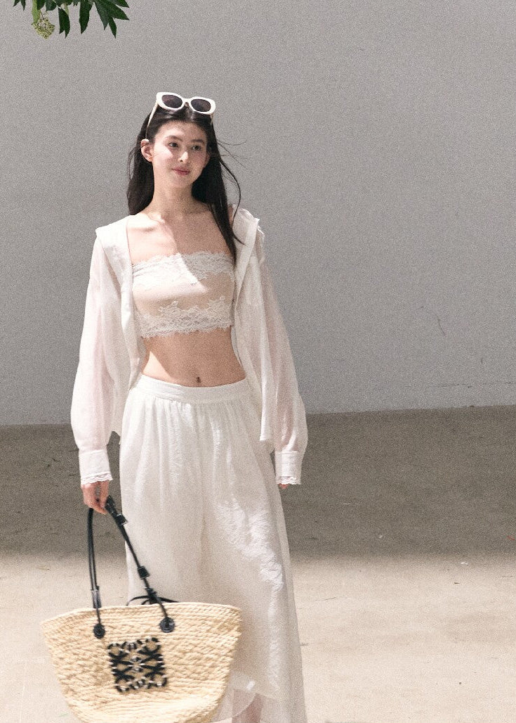 Airy white shirt cardigan layered over a lace bralette
