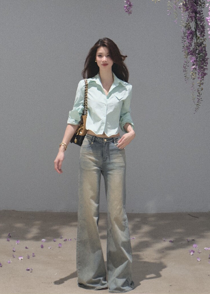 Vintage distressed denim jeans with a subtle flared silhouette