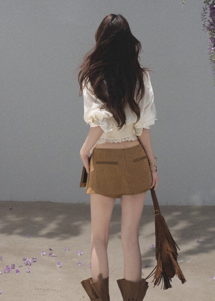 Ivory ribbon-tie cropped blouse with a softly gathered waist