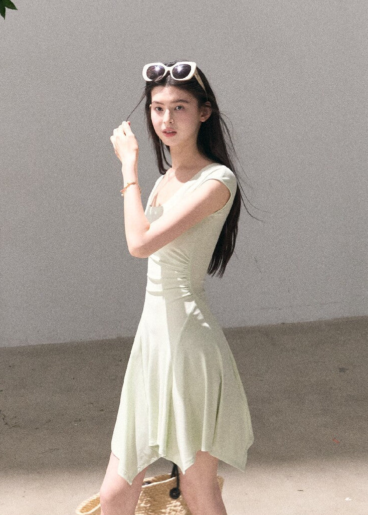 Soft green sleeveless midi dress with elegant drape