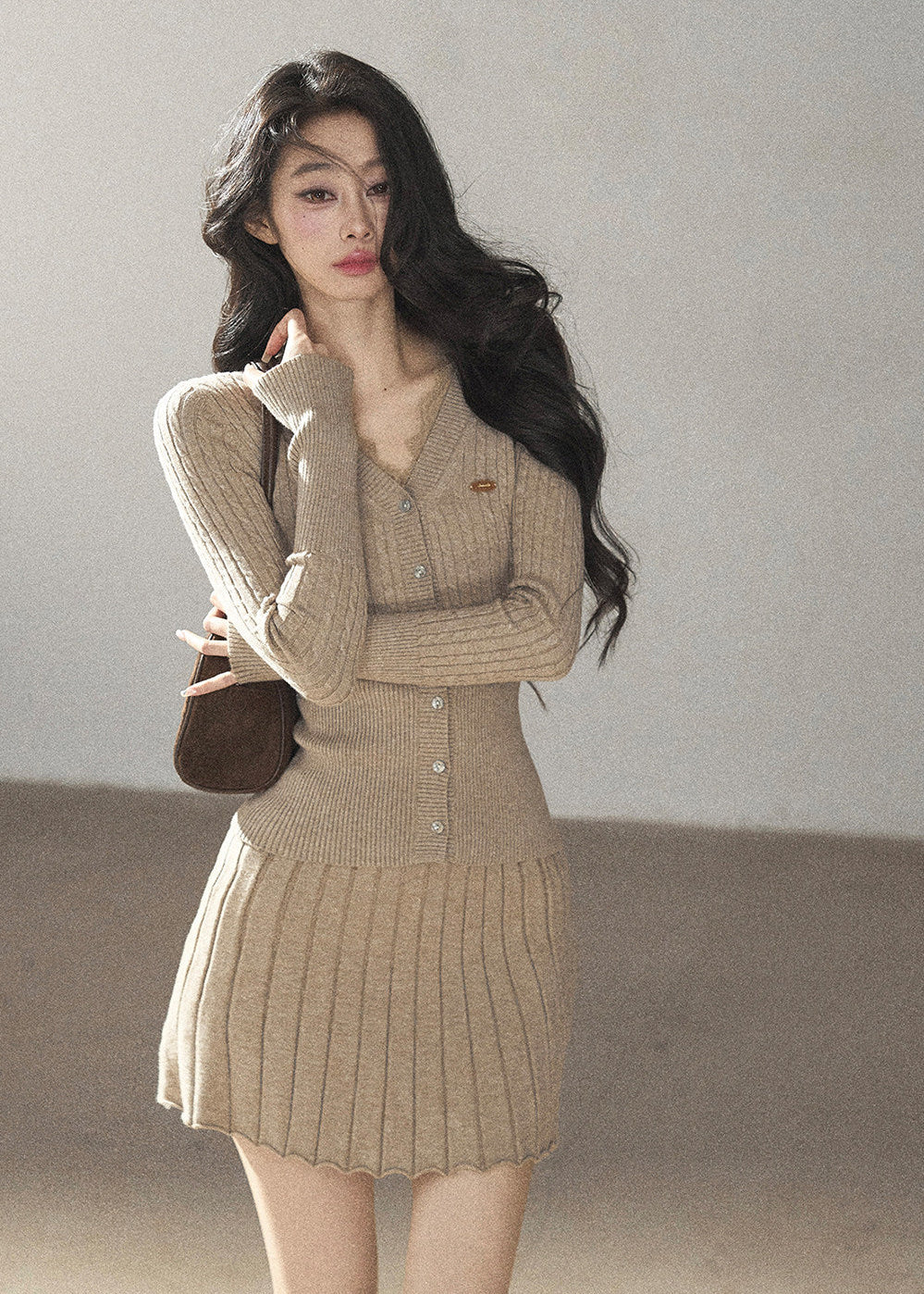 Women's fitted V-neck button cardigan with matching pleated knit skirt