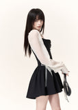 Black and white contrast mini dress with sheer long sleeves