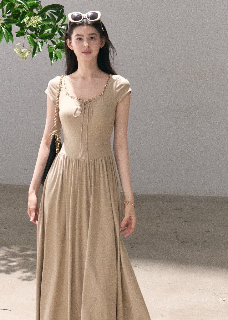 Beige tie-detail maxi dress with flowing skirt