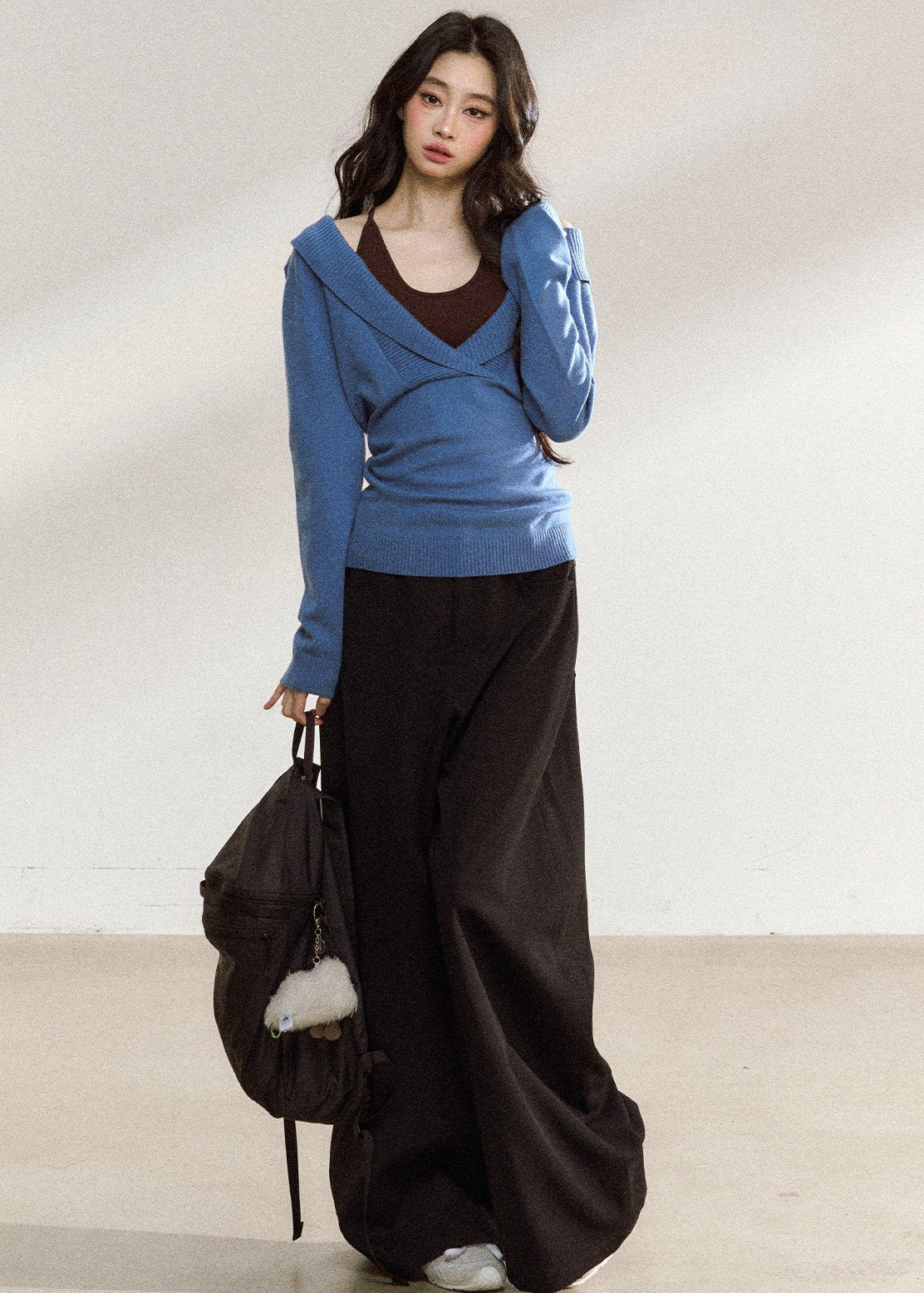 Women’s blue wrap-front sweater with relaxed shoulders