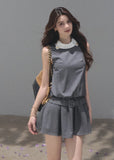 Belted gray mini dress featuring a softly pleated flared skirt