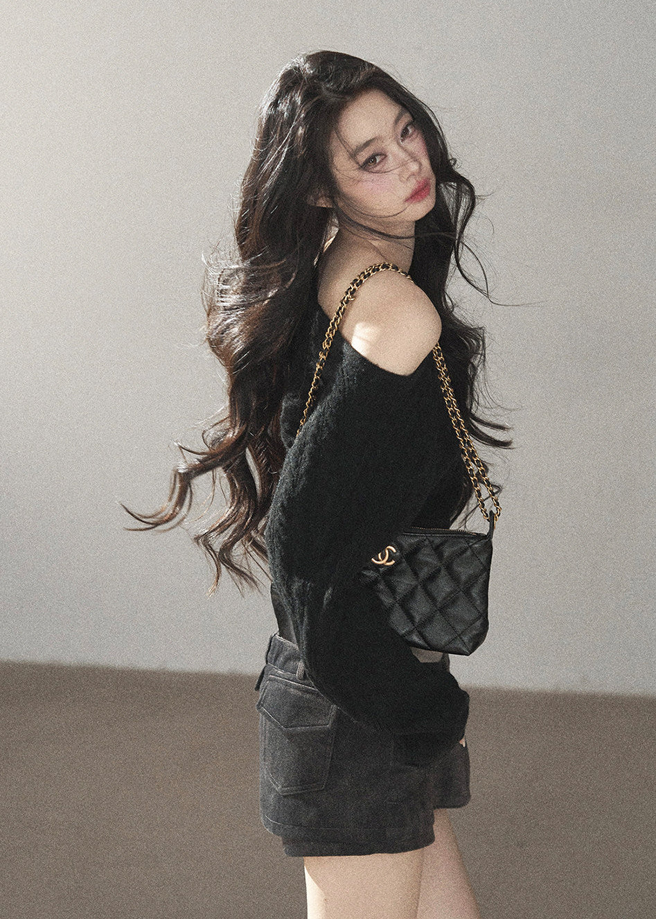 Black asymmetric off-shoulder cable knit sweater with long sleeves