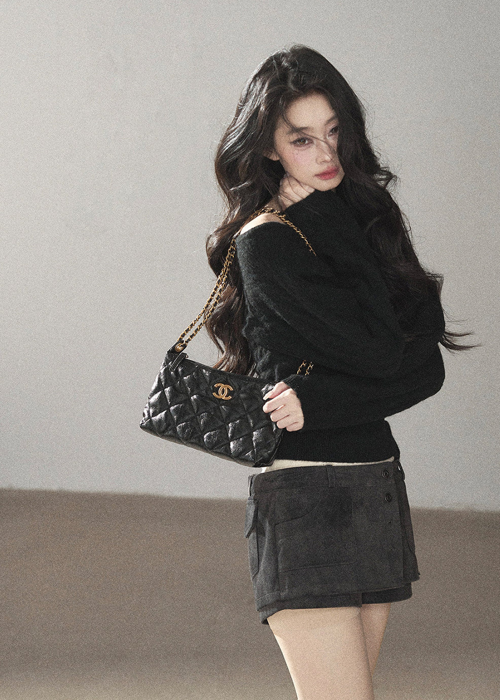 Black asymmetric off-shoulder cable knit sweater with long sleeves
