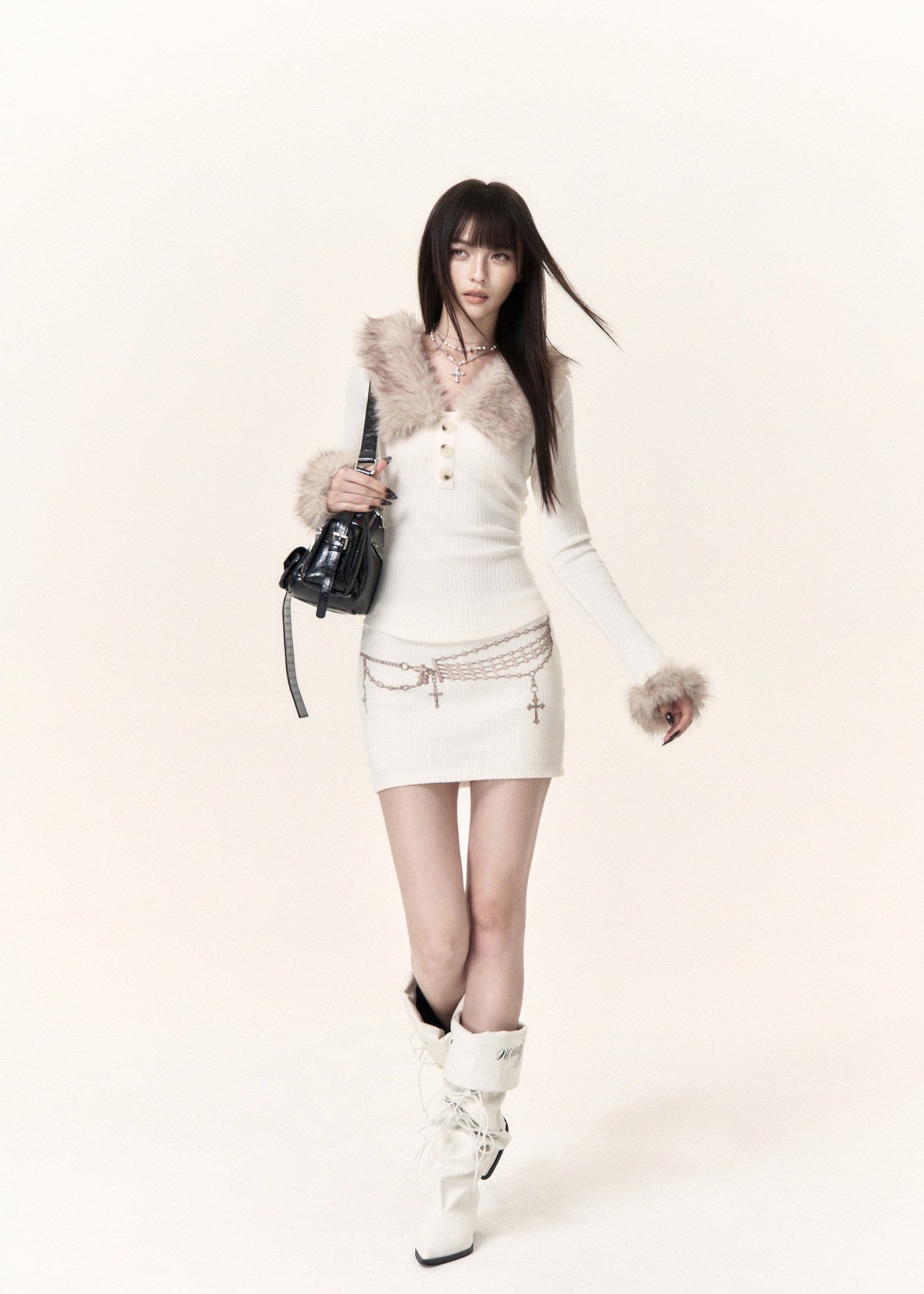 White long sleeve knit top with beige faux fur trim and fitted mini skirt