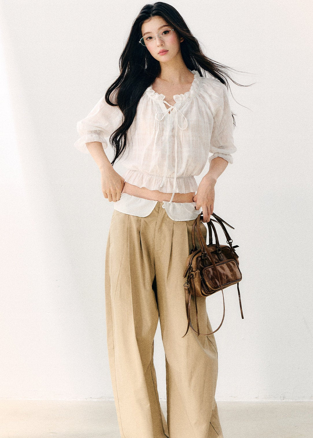 Women’s white cropped blouse with a ruffled hem