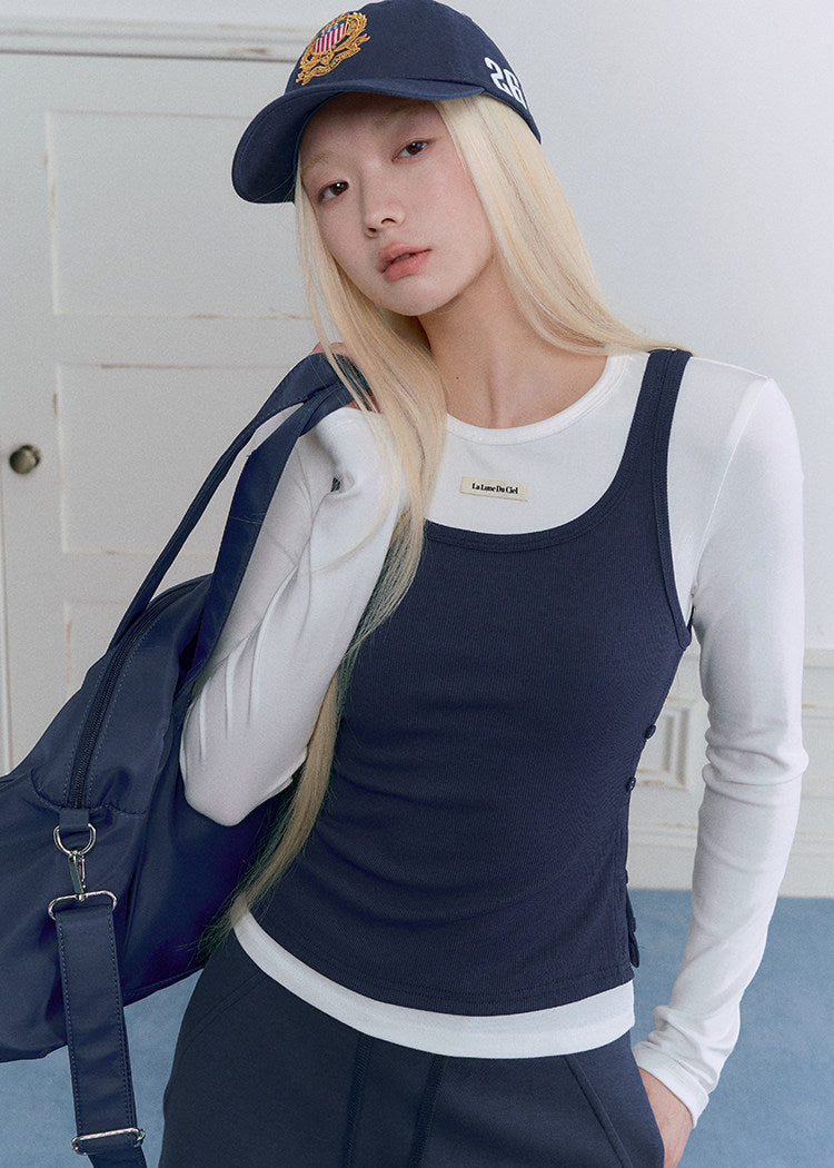Model wearing a navy and white faux-layered top with a drawstring mini skirt
