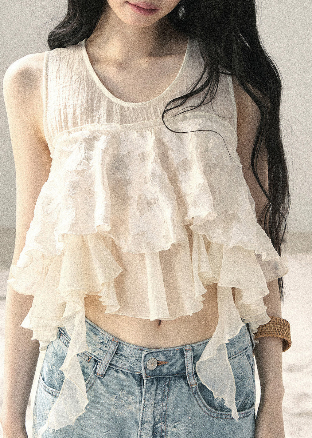 Romantic ivory sleeveless top with layered asymmetric ruffle details