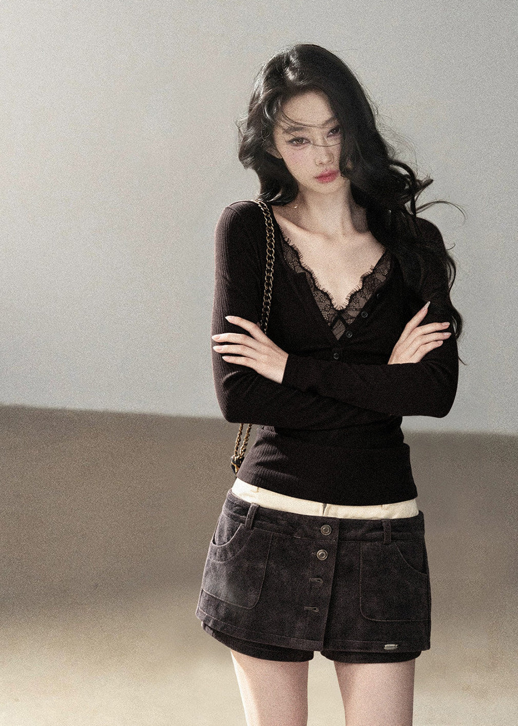 Feminine black lace-detail fitted top styled with denim mini skirt