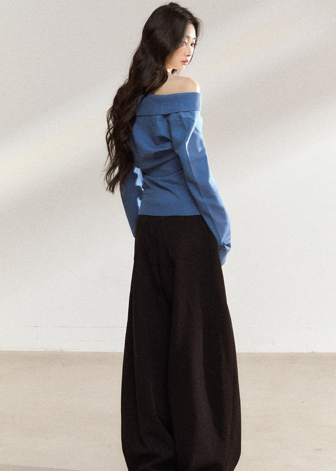 Women’s blue wrap-front sweater with relaxed shoulders