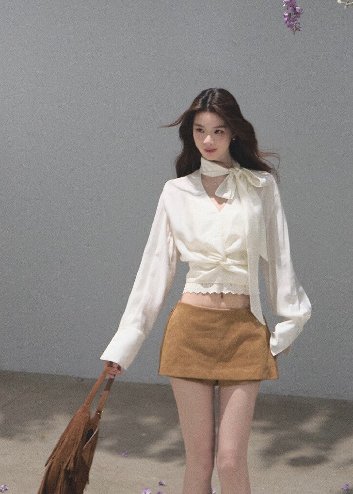 Ivory ribbon-tie cropped blouse with a softly gathered waist