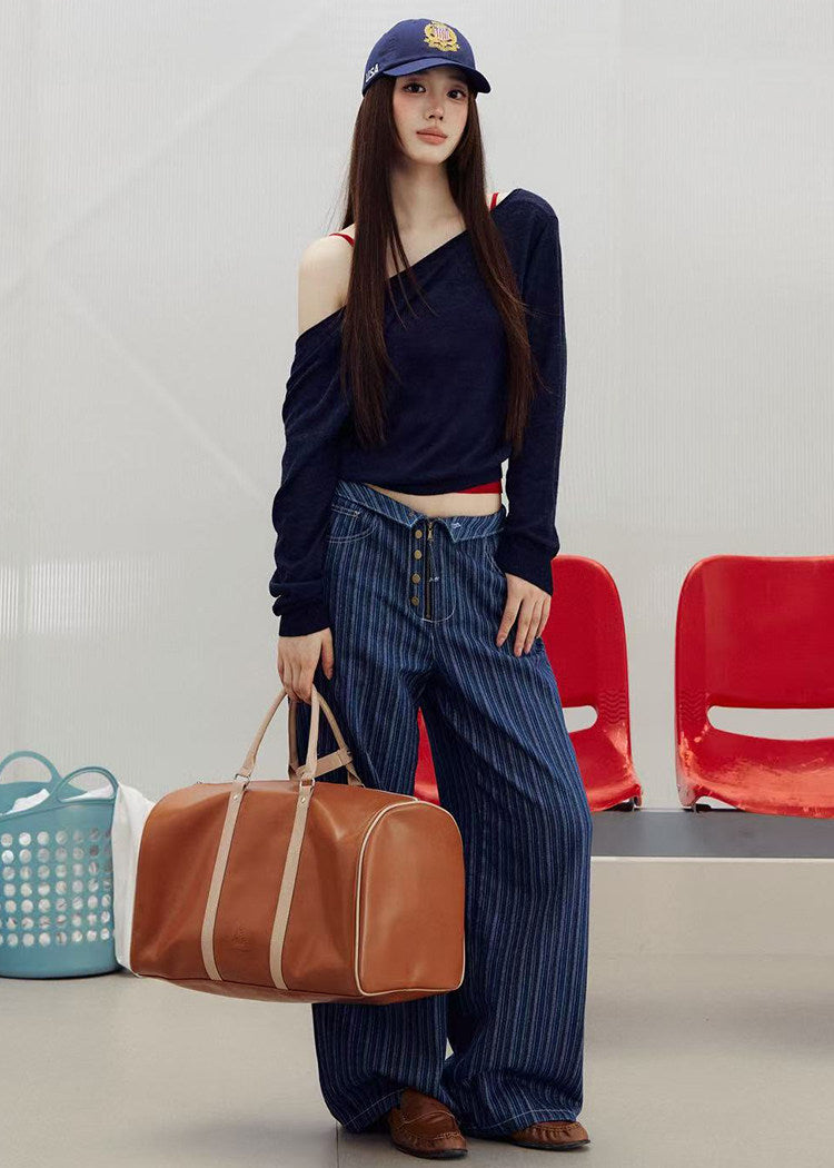 1. Model wearing a fitted red knit camisole with a low neckline and a navy cap