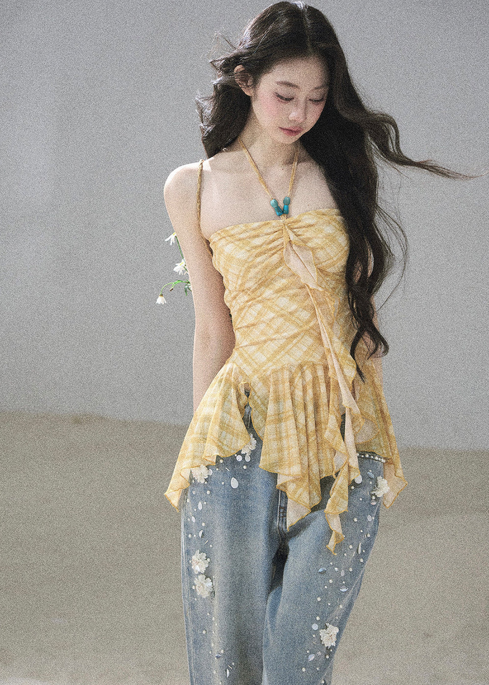 Yellow ruffle-hem summer top styled with embellished jeans