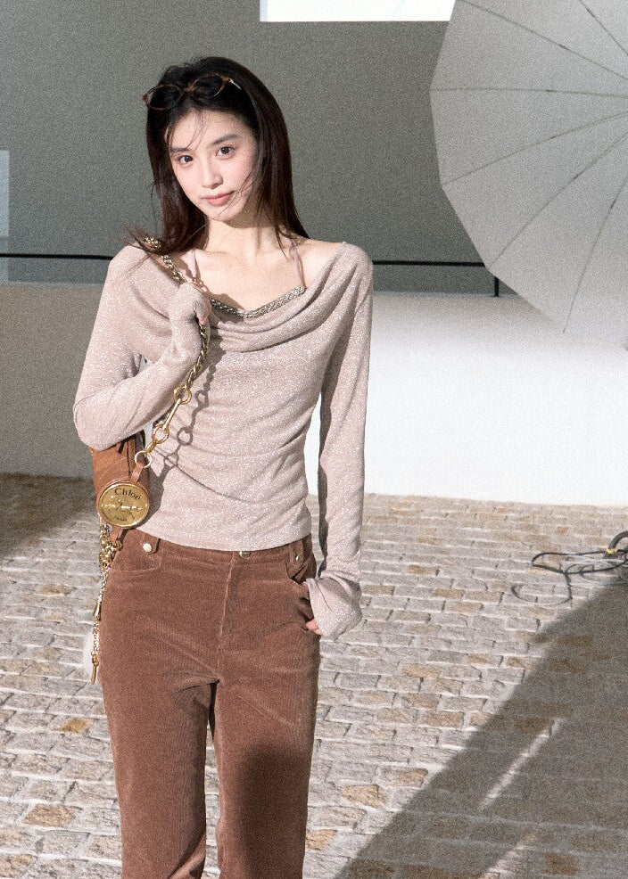 Elegant off-shoulder long sleeve top styled with brown trousers