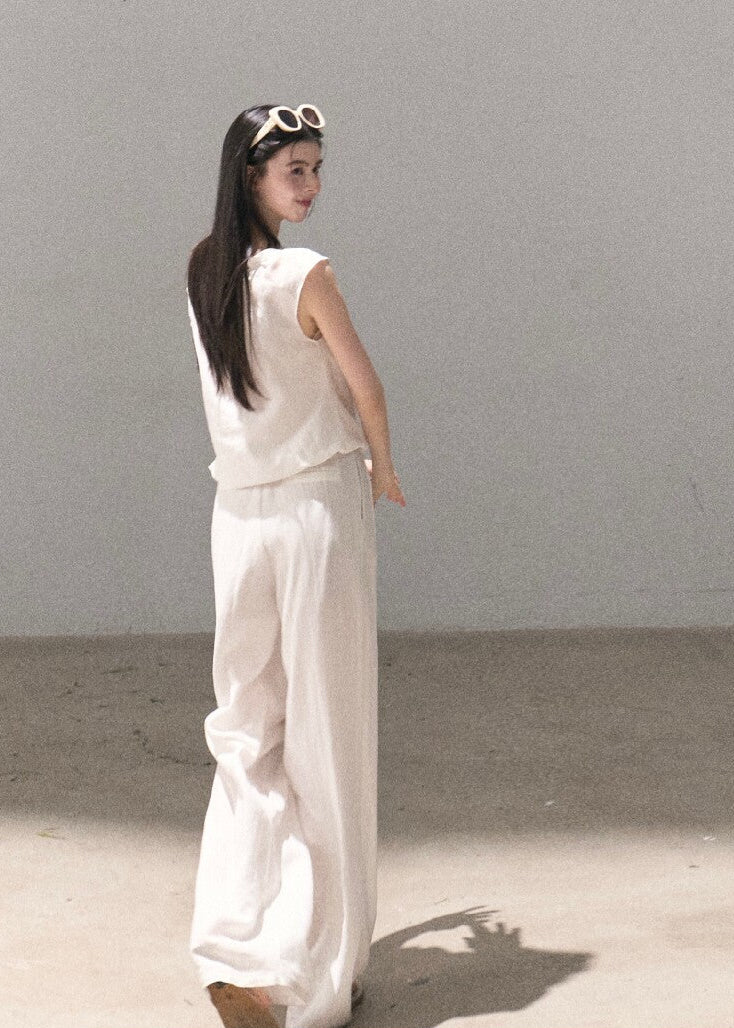 Asymmetric off-shoulder top styled with relaxed pants